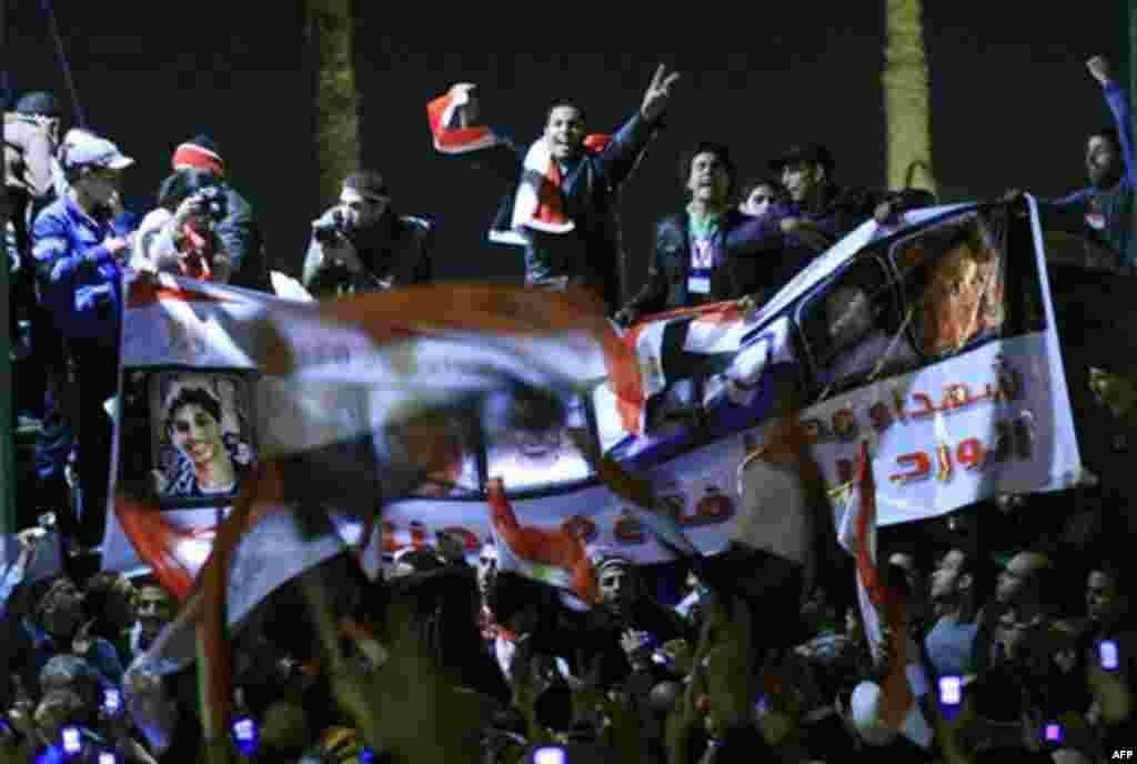 Anti-government protesters celebrate in Tahrir Square in downtown Cairo, Egypt Thursday, Feb. 10, 2011 with a giant poster showing "the martyrs of the revolution". Egypt's military announced on national television it had stepped in to secure the country a