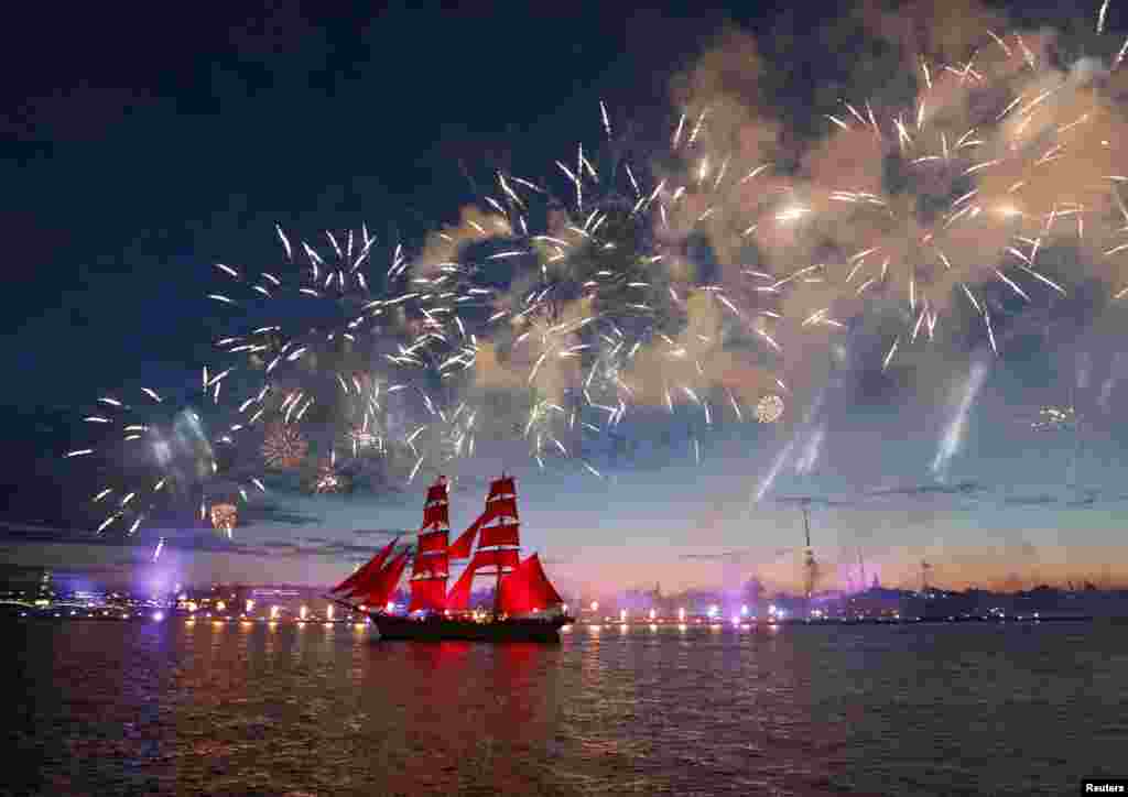 Fireworks explode over Sweden&#39;s brig Tre Kronor with scarlet sails which floats on the Neva River during the Scarlet Sails festivities marking school graduation, in St. Petersburg, Russia, June 24, 2017.