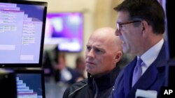 Specialists John O'hara, left, and David Haubner work on the floor of the New York Stock Exchange, Nov. 15, 2016.