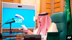 In this photo released by Saudi Press Agency, Saudi King Salman chairs a video conference of world leaders from the Group of 20 and other international bodies and organizations, from his office in Riyadh, Saudi Arabia, March 26, 2020. 