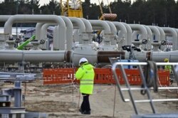 FILE - Men work at the construction site of the so-called Nord Stream 2 gas pipeline in Lubmin, northeastern Germany, March 26, 2019.