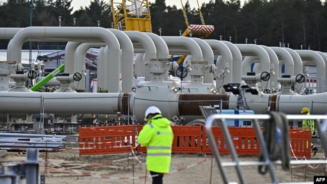 FILE - Men work at the construction site of the Nord Stream 2 gas pipeline in Lubmin, northeastern Germany, March 26, 2019.