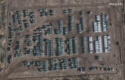 FILE - This handout satellite image taken Nov. 1, 2021, and released by Maxar Technologies shows the presence of a large ground force deployment near Yelnya, Smolensk region, Russia, about 260 kilometers (160 miles) north of the Ukrainian border.
