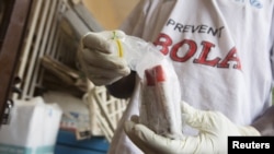 Blood samples from patients suspected of having the Ebola virus are prepared for transportation to Freetown for testing, at the Port Loko District Hospital, Sept. 27, 2014.