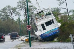 A boat is washed up near a road after Hurricane Sally moved through the area, Sept. 16, 2020, in Orange Beach, Ala.