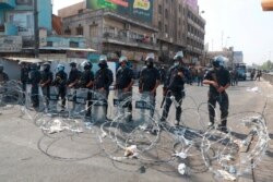 Iraqi security forces close streets to prevent anti-government protesters from reaching Tahrir Square in central Baghdad, Iraq, Oct. 2, 2019.