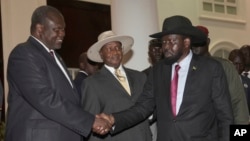 FILE - Former Vice President of South Sudan Riek Machar, left, greets South Sudan President Salva Kiir, right, as Uganda President Yoweri Museveni looks on, July 7, 2018, Uganda. A report released Thursday says Uganda diverted European weapons to South Sudan despite an EU ban.