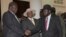 FILE - Former Vice President of South Sudan Riek Machar, left, greets South Sudan President Salva Kiir, right, as Uganda President Yoweri Museveni looks on, July 7, 2018, Uganda. A report released Thursday says Uganda diverted European weapons to South Sudan despite an EU ban.