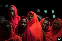 A group of migrants rescued by Spanish maritime authorities stand on a rescue vessel as they arrive at Malaga port, Spain, February 11, 2020.