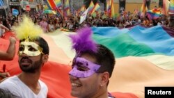 Participants wave a huge rainbow flag during a gay pride parade in Istanbul, June 30, 2013. Tens of thousands of anti-government protesters teamed up with a planned gay pride march in Istanbul.