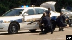  In this image made from video and released by WRCB-TV, authorities work an active shooting scene on Amincola highway near the Naval Reserve Center in Chattanooga, Tennessee, July 16, 2015.