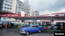 A vintage car leaves a gas station operated by Cimex corporation in Havana, Cuba, May 3, 2019. 