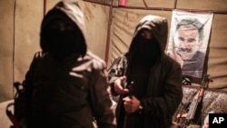 FILE - Militants of the Kurdistan Workers' Party, or PKK, stand in a bunker in Sirnak, Turkey, Dec. 23, 2015.