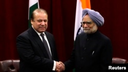 FILE - Pakistan's Prime Minister Nawaz Sharif (L) shakes hands with India's Prime Minister Manmohan Singh during the United Nations General Assembly in New York.
