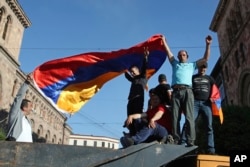 Supporters of opposition lawmaker Nikol Pashinyan wave an Armenian flag during a demonstration in Republic Square in Yerevan, May 2, 2018.