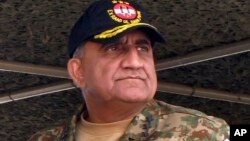 In this Wednesday, Nov. 16, 2016 photo, Pakistan's army senior officer Lt. Gen. Qamar Javed Bajwa attends a military exercise in Khairpur Tamiwali, Pakistan. 