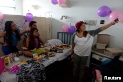 Lismar Castellanos, 21, who lost her transplanted kidney, takes a selfie with her mother and friends during her birthday celebration at a state hospital in Caracas, Venezuela, Feb. 7, 2018.