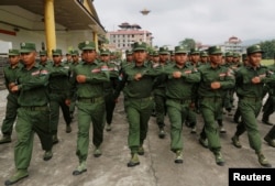 FILE - United Wa State Army (UWSA) soldiers march during a display for the media in Pansang, Wa territory in north east Myanmar, Oct. 4, 2016.