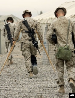 US Marines of the 1st Division walk to a briefing prior to a mission outside Fallujah, Iraq, November 1, 2004.