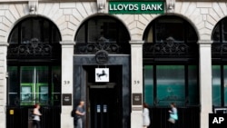 Pedestrians pass a branch of Lloyds Bank in London, July 28, 2016. 