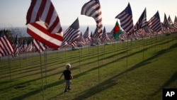 A boy runs among flags flying at Pepperdine University in honor of the victims of the September 11, 2001 attacks, Malibu, California, September 10, 2012.