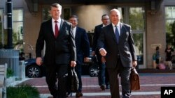 The defense team for Paul Manafort, including, Kevin Downing (L), and Thomas Zehnle (R) arrive at the Albert V. Bryan United States Courthouse for the trial of former Trump campaign chairman, Aug. 10, 2018, in Alexandria, Va.