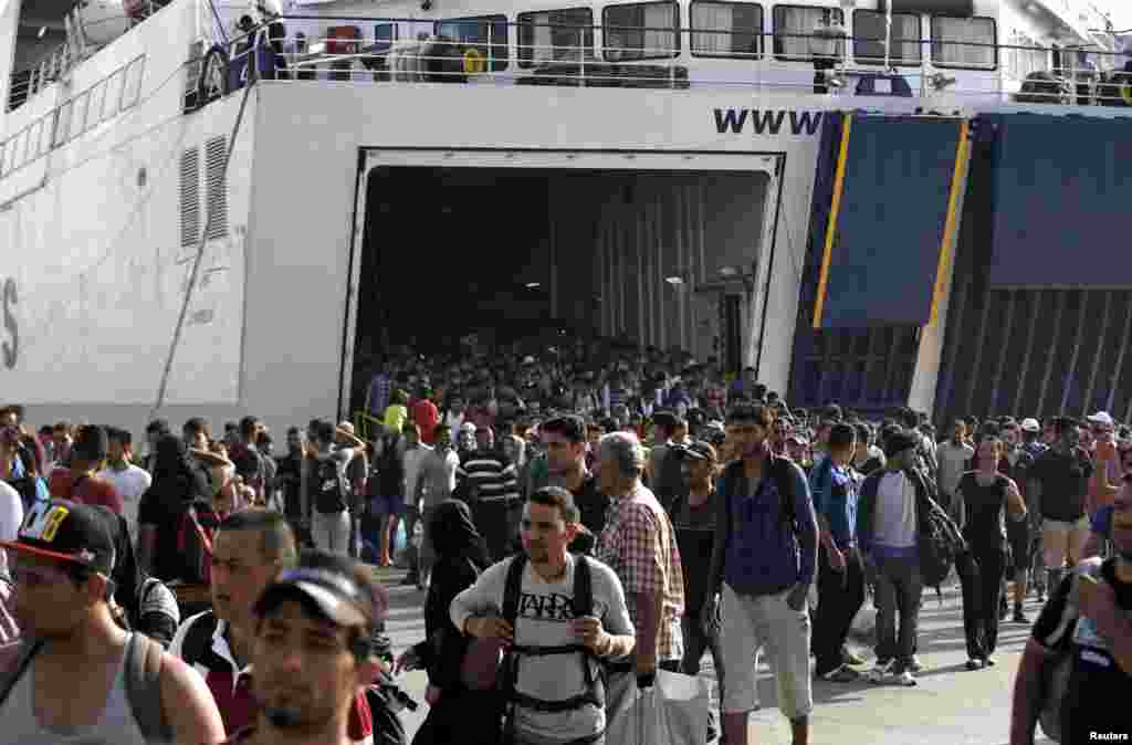 Refugees and migrants arrive onboard the Tera Jet passenger ship at the port of Piraeus, near Athens, Greece, Sept. 6, 2015.