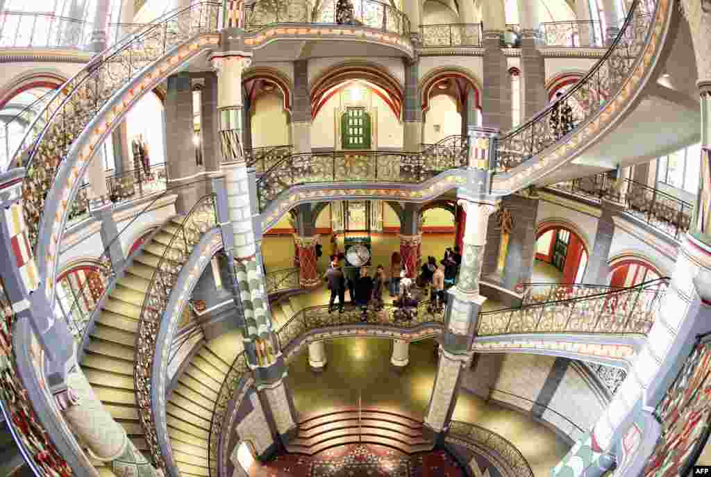 Visitors stand in the staircase of the restored former Prussian justice palace, that serves now as county court in Halle an der Saale, eastern Germany. The 110-year-old building housing 20 courtrooms, 110 offices and further 100 rooms re-opened after two years of restoration.