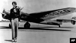 Amelia Earhart, 40, stands next to a Lockheed Electra 10E, before her last flight in 1937 from Oakland, California, bound for Honolulu.