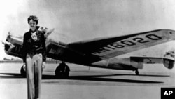 Amelia Earhart, 40, stands next to a Lockheed Electra 10E, before her last flight in 1937 from Oakland, Calif., bound for Honolulu.