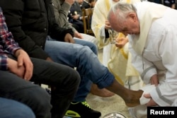 FILE - Pope Francis washes the foot of a prisoner at Casal del Marmo youth prison in Rome March 28, 2013.
