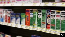 FILE - Cough syrup containing dextromethorphan is displayed at a pharmacy in Edmond, Okla.