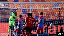 DR Congo's goalkeeper Ley Matampi (1st-L) misses the ball as Uganda's forward Patrick Kaddu (unseen) scores during the 2019 Africa Cup of Nations (CAN) football match between DR Congo and Uganda at Cairo International Stadium on June 22, 2019. (Photo by JAVIER SORIANO / AFP)