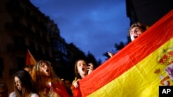 Anti-independence demonstrators waving Spanish flags shout slogans during a protest in Barcelona, Oct. 4, 2017.