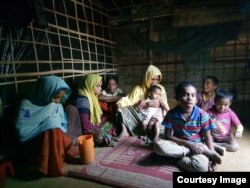 Rohingya refugee Samsun Nahar, a widow with nine children, is searching for "two good boys" to marry her 14 and 13-year old daughters as soon as possible. (Photos by Noor Hossain)