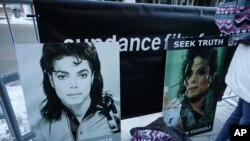 Signs in support of Michael Jackson are seen outside of the premiere of the 'Leaving Neverland' Michael Jackson documentary film at the Egyptian Theatre on Main Street during the 2019 Sundance Film Festival, Jan. 25, 2019, in Park City, Utah.