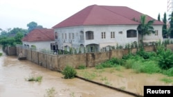 Newly-built houses on the bank of the River Kaduna are seen in flood waters after hours of rainfall in Kaduna, Nigeria, Aug. 15, 2015.