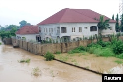 FILE - Newly-built houses on the bank of the River Kaduna are seen in flood waters after hours of rainfall in Kaduna, Nigeria, August 15, 2015.