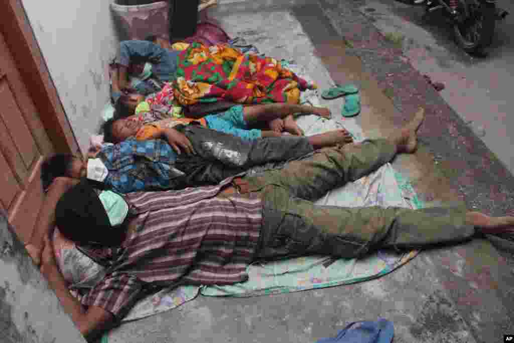 Villagers sleep at a temporary shelter after they were evacuated from their homes on the slopes of Mount Kelud in Kediri, East Java, Indonesia, Feb. 14, 2014. 