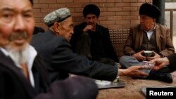 FILE PHOTO - Uighur men drink tea in the old town in Kashgar, Xinjiang Uighur Autonomous Region, China, March 22, 2017. REUTERS/Thomas