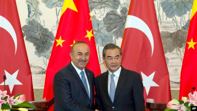 中国外长王毅和土耳其外长查武什奥卢在北京钓鱼台国宾馆举行了联合记者会后握手。（2017年8月3日）