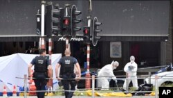 Forensic police, right, investigate at the scene of a shooting in Liege, Belgium, May 29, 2018. 