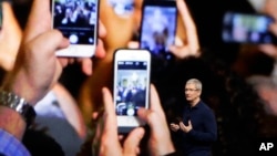 FILE - Apple CEO Tim Cook announces the new iPhone 7 during an event to announce new products, in San Francisco. 