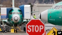 Boeing 737 MAX jets are parked Monday, Dec. 16, 2019, in Renton, Wash. Boeing will temporarily stop producing its grounded 737 MAX jet starting in January as it struggles to get approval from regulators to put the plane back in the air. (AP Photo/Elaine Thompson) 