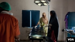 A nurse prepares the operating table for surgery, Ras Kamboni, Somalia, July 6, 2012. (VOA - R. Gogineni)