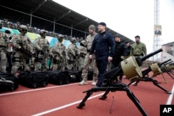 Chechnya's regional leader Ramzan Kadyrov, foreground center, inspects Chechen special forces in Grozny, Russia, Dec. 28, 2014.