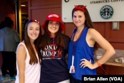 Three Donald Trump supporters, students at Hofstra University in Hempstead, New York, pose for a photo in the dining hall ahead of Monday's presidential debate on campus (B. Allen/VOA)