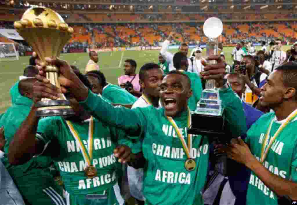 Nigeria's Emmanuel Emenike holds the trophy after they defeated Burkina Faso in the final to win the African Cup of Nations at the Soccer City Stadium in Johannesburg, South Africa, Sunday, Feb. 10, 2013. (AP Photo/Armando Franca)