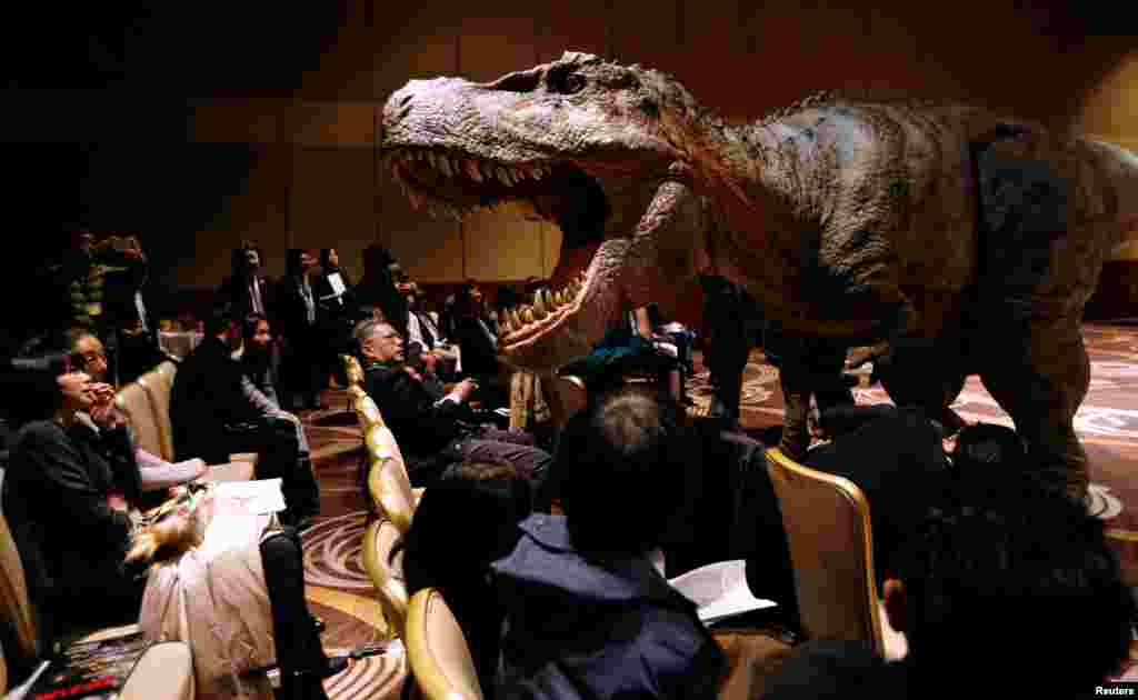 Japan's On-Art Corp's eight-meter-tall dinosaur-shaped mechanical suit robot 'TRX03' performs during its unveiling in Tokyo.
