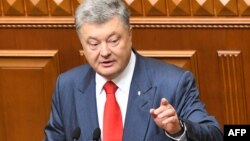 Ukrainian President Petro Poroshenko addresses lawmakers in Ukraine's Parliament in Kyiv, Ukraine, Sept. 20, 2018.